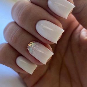milky manicure with glitter